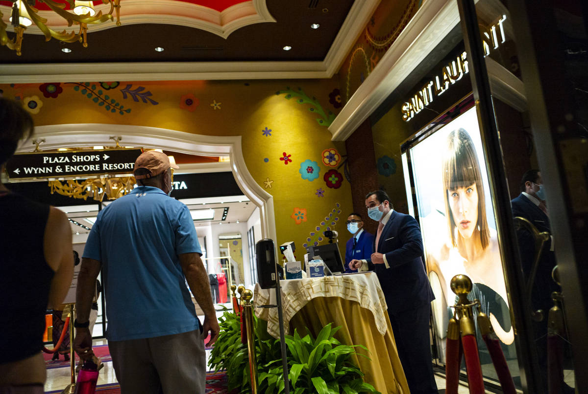 People pass through thermal scanners at the Wynn Las Vegas in Las Vegas on Saturday, June 27, 2 ...