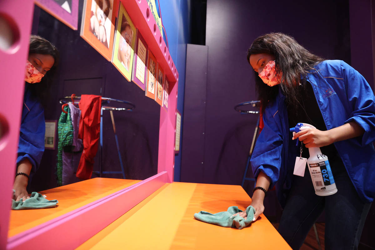 Intern Nigel Simon cleans a kids area at the Children's Discovery Museum in Las Vegas, Wednesda ...