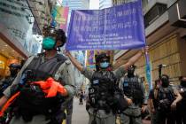 Police display a public announcement banner showing the warning to protesters in Causeway Bay b ...