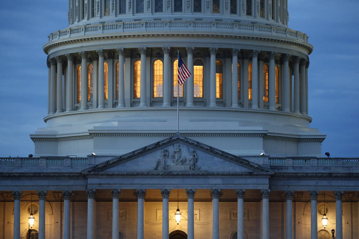 FILE - In this May 3, 2020, file photo, light shines from inside the U.S. Capitol dome at dusk ...