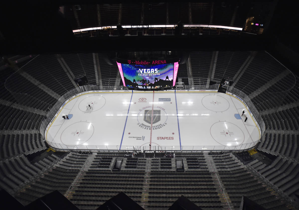 Workmen prepare the T-Mobile Arena ice before the start of an NHL hockey game between the Vegas ...