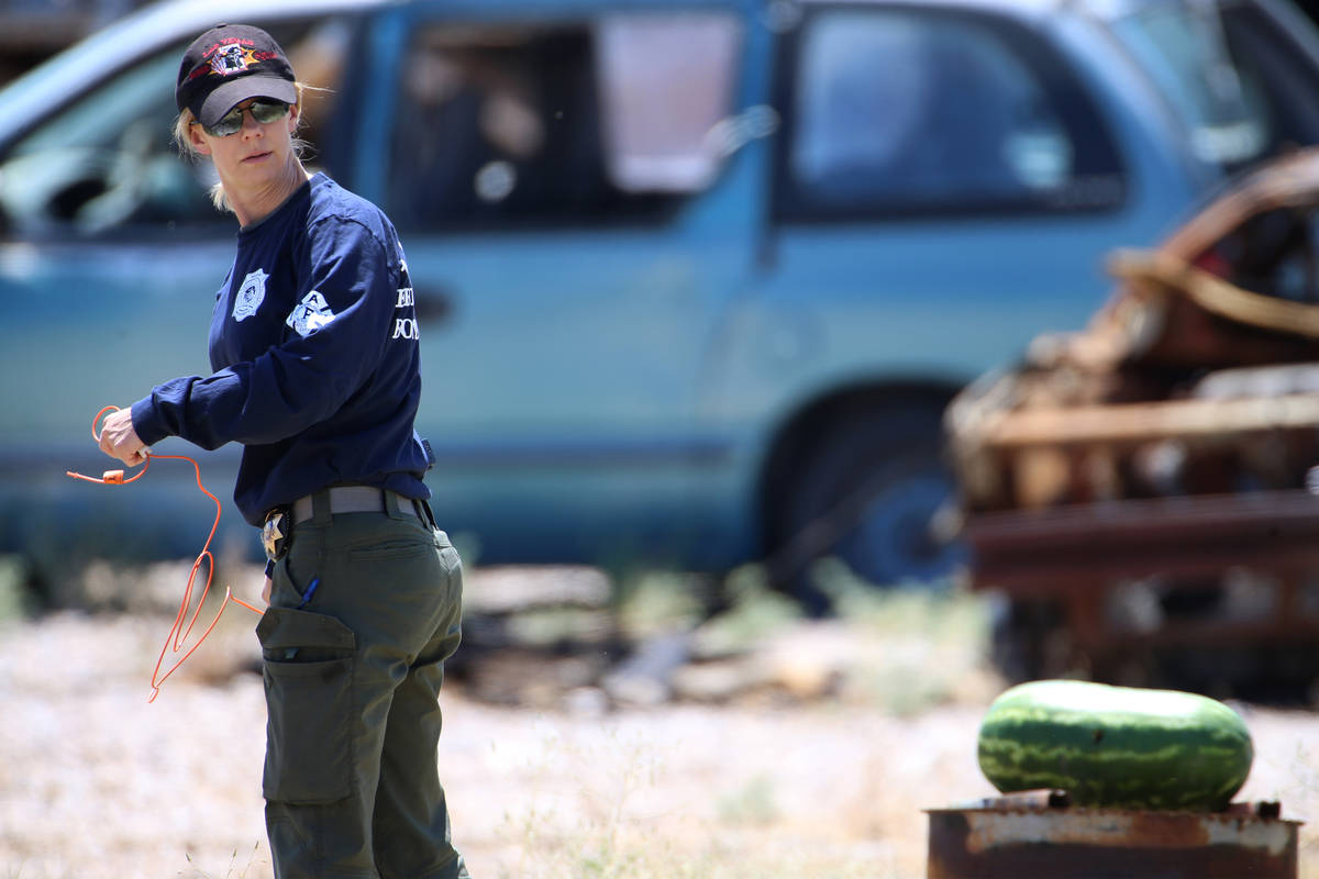 Laura Brown, senior bomb technician with Las Vegas Fire and Rescue, sets up a charge to blow up ...
