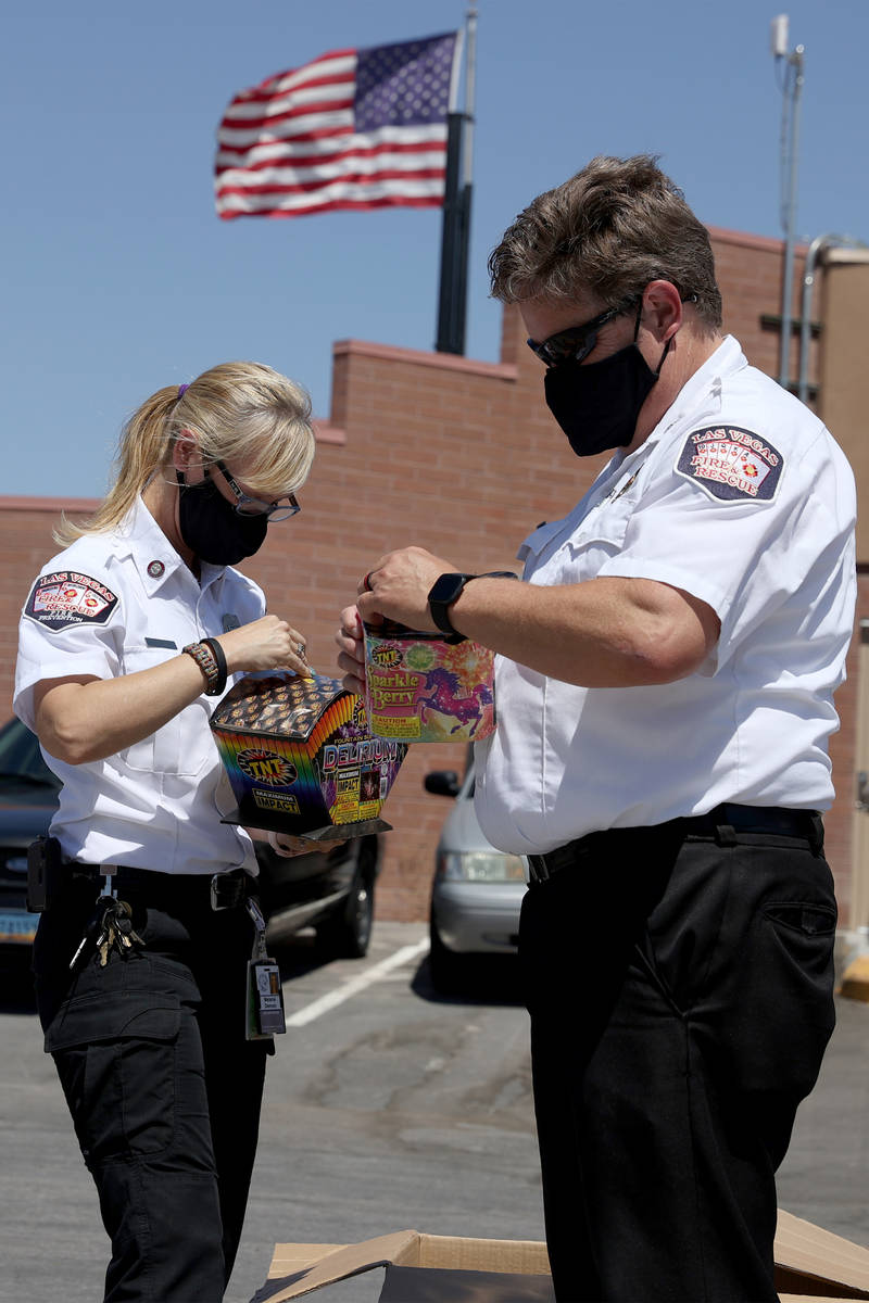Las Vegas Fire and Rescue's fire inspectors Melanie Dennon, left, and Scott Thompson, give a de ...