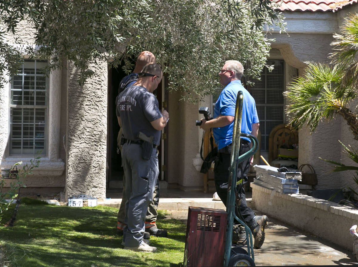 The Clark County firefighters investigate the cause of a shed fire that spread to the home in t ...