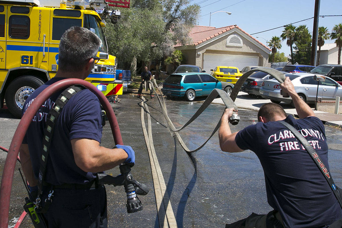 The Clark County firefighters wrap up after battling a shed fire that spread to the home in the ...