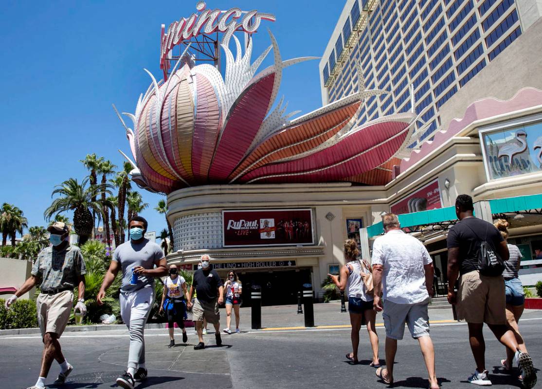 Tourists walk along Las Vegas Boulevard near the Flamingo on Friday, July 3, 2020, in Las Vegas ...