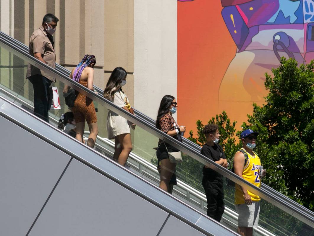 Tourists use an escalator near New York-New York and the MGM Grand on Friday, July 3, 2020, in ...