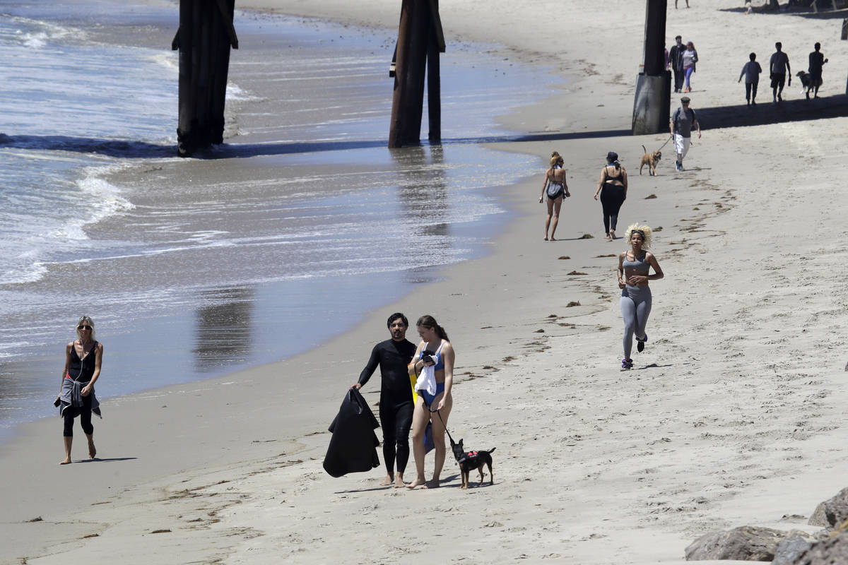 Visitors walk and exercise on the beach Wednesday, May 13, 2020, in Malibu, Calif. (AP Photo/Ma ...