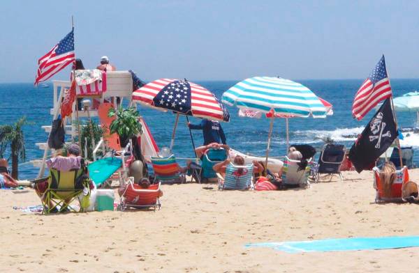 Flags line the beach in Belmar, N.J., on June 28, 2020. With large crowds expected at the Jerse ...