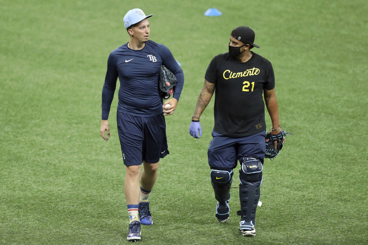 Tampa Bay Rays' Blake Snell, left, talks with bullpen catcher Jean Ramirez during baseball prac ...