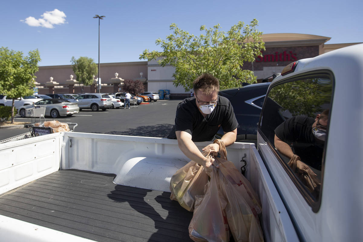 Mason Stanley unloads groceries from the Smith's Food & Drug on West Charleston Boulevard a ...