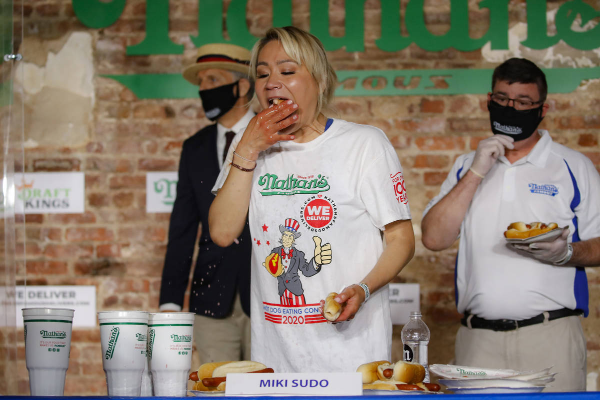 Competitive eater Miki Sudo eats a record 48 and a half hot dogs to win the women's division of ...