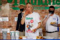 Competitive eater Miki Sudo eats a record 48 and a half hot dogs to win the women's division of ...