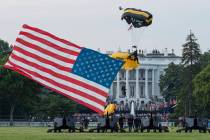 President Donald Trump and first lady Melania Trump watch as the U.S. Army Golden Knights Parac ...