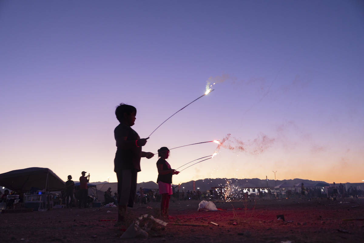 Individuals light off fireworks near Moapa Paiute Travel Plaza during Fourth of July festivitie ...