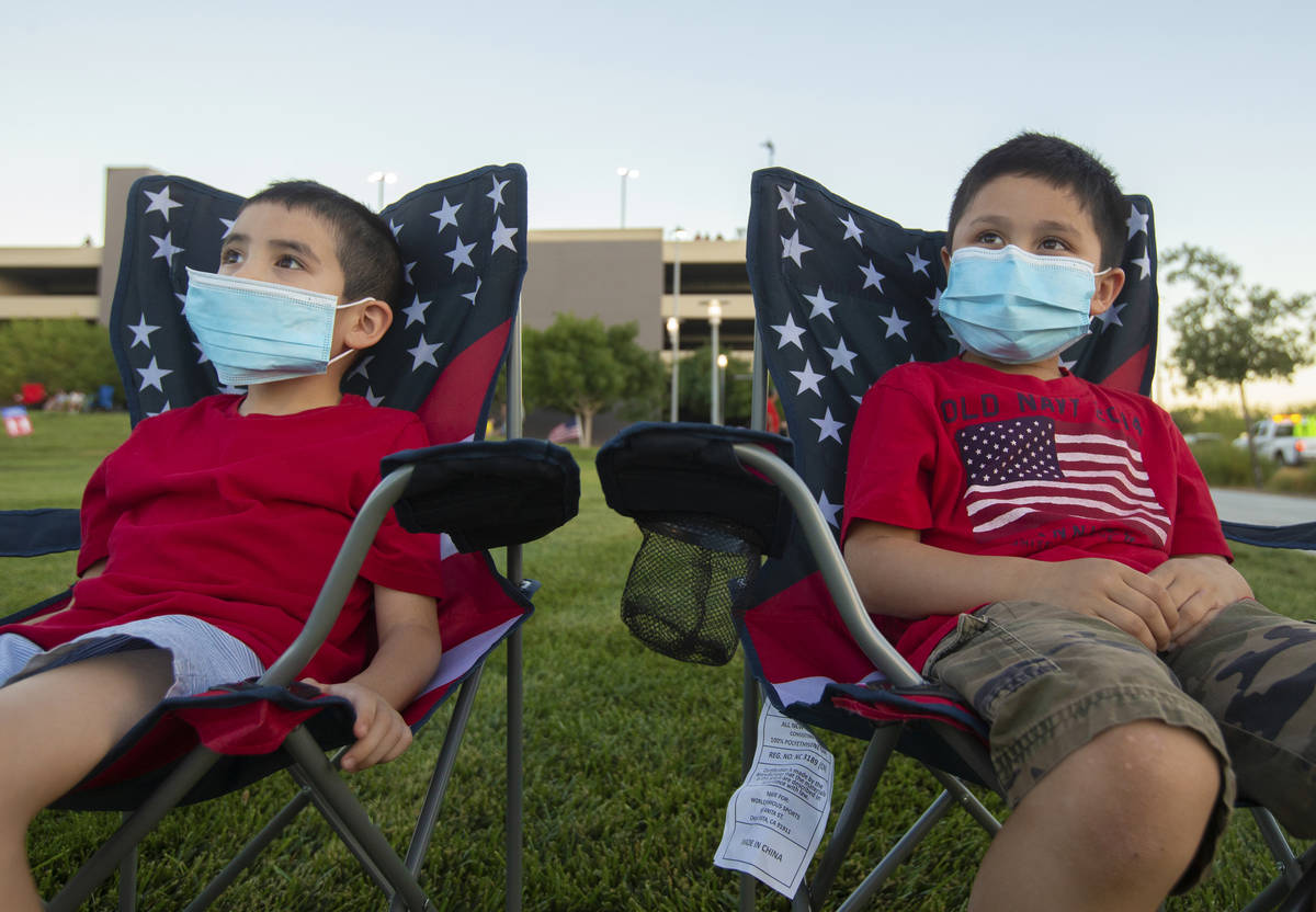 James Watson, left, 7, and brother Thomas, 6, wait for the start of the Red Rock Casino firewor ...