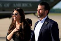 Donald Trump Jr., right, walks with his girlfriend, Kimberly Guilfoyle, after arriving at Andre ...