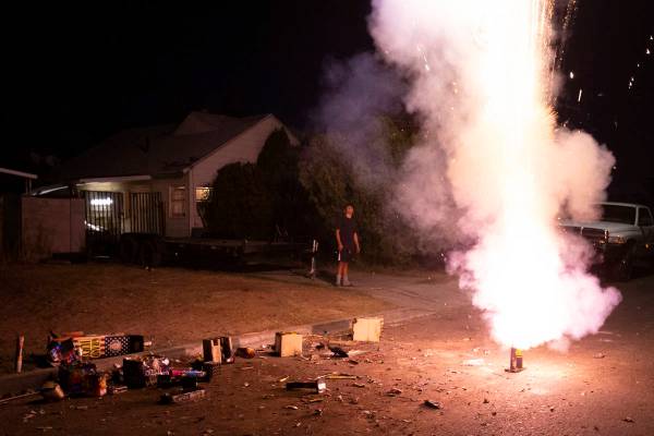 A group sets off fireworks on their street to celebrate Independence Day on Saturday, July 4, 2 ...