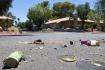 Exploded fireworks litter the street next to Riverbend Village Apartments, which was the site o ...