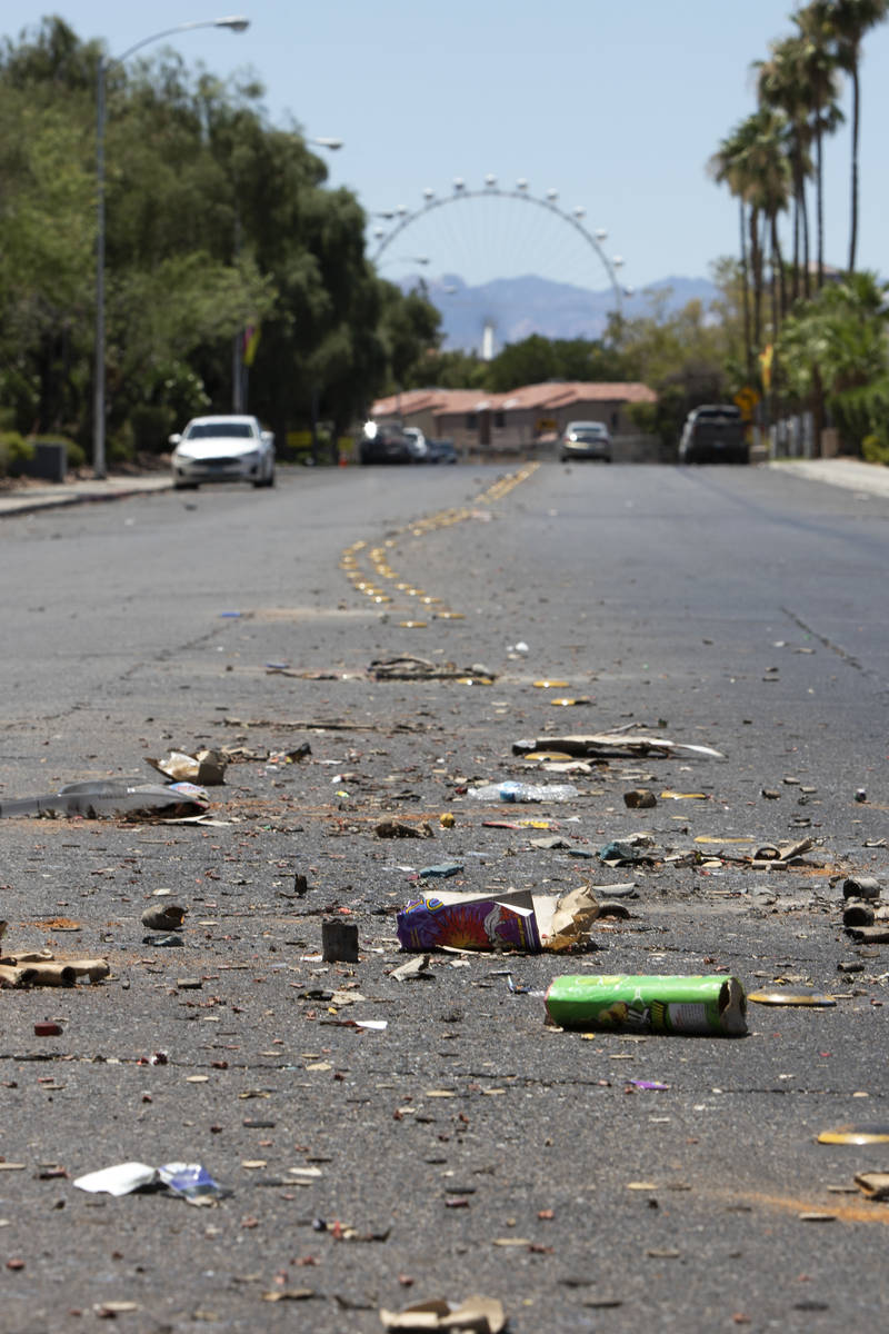 Exploded fireworks litter the street next to Riverbend Village Apartments, which was the site o ...