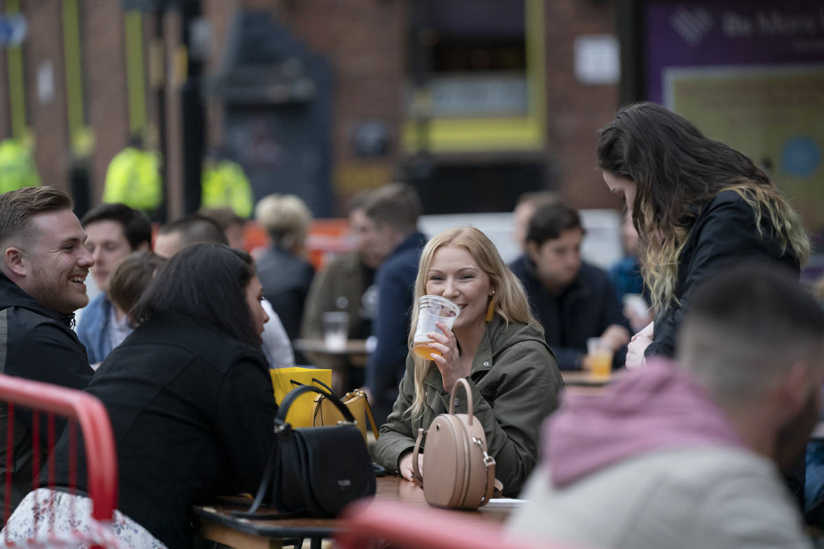 Members of the public are seen at a bar in Manchester's Northern Quarter, England, Saturday Jul ...