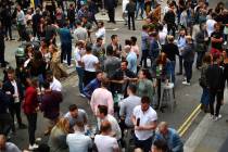 Drinkers in Soho congregate, as coronavirus lockdown restrictions eased across England, in Lond ...