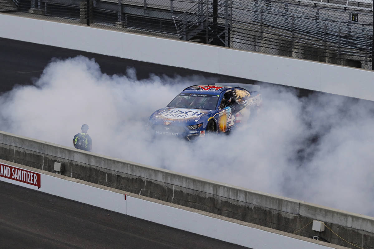 Kevin Harvick does a burnout after winning the NASCAR Cup Series auto race at Indianapolis Moto ...