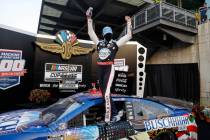 Race driver Kevin Harvick celebrates after winning the NASCAR Cup Series auto race at Indianapo ...