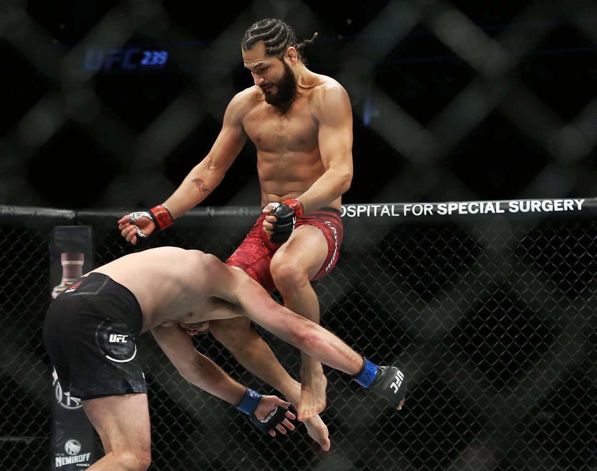 Jorge Masvidal, top/right, connects with a flying knee knocking out Ben Askre in the first roun ...