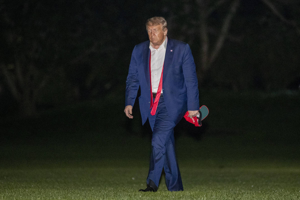 FILE - In this June 21, 2020, file photo, President Donald Trump walks on the South Lawn of the ...