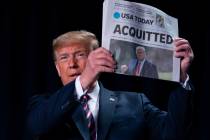 In a Feb. 6, 2020, file photo, President Donald Trump holds up a newspaper with the headline th ...