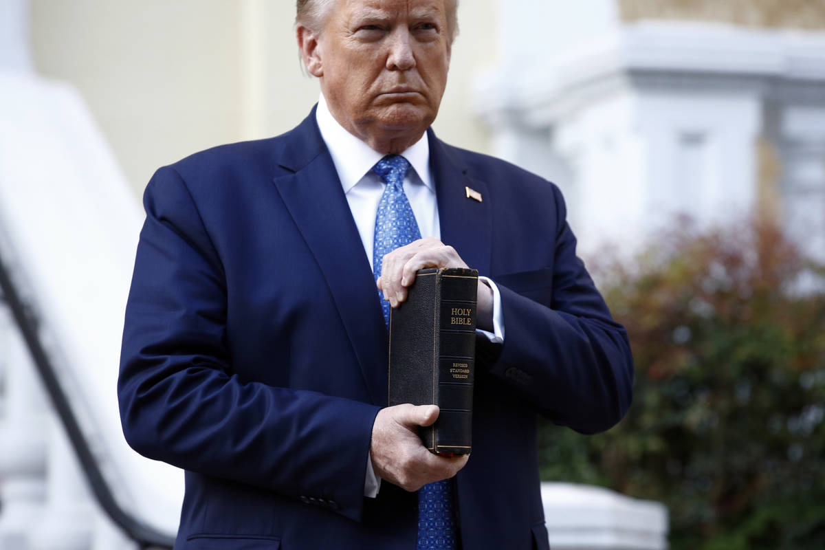 FILE - In this June 1, 2020, file photo, President Donald Trump holds a Bible as he visits outs ...