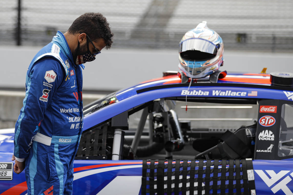 Bubba Wallace stands next to his car during a prayer before a NASCAR Cup Series auto race at In ...