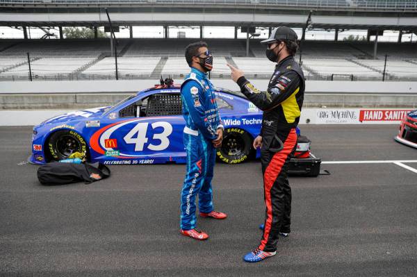 Bubba Wallace, left, and Corey LaJoie talk before a NASCAR Cup Series auto race at Indianapolis ...