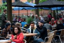Members of the public are seen at a bar on Canal Street in Manchester's gay village, England, S ...