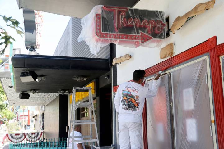 Ismael, left, and Nelson, of CertaPro Painters, who declined to give their last names, paint T ...