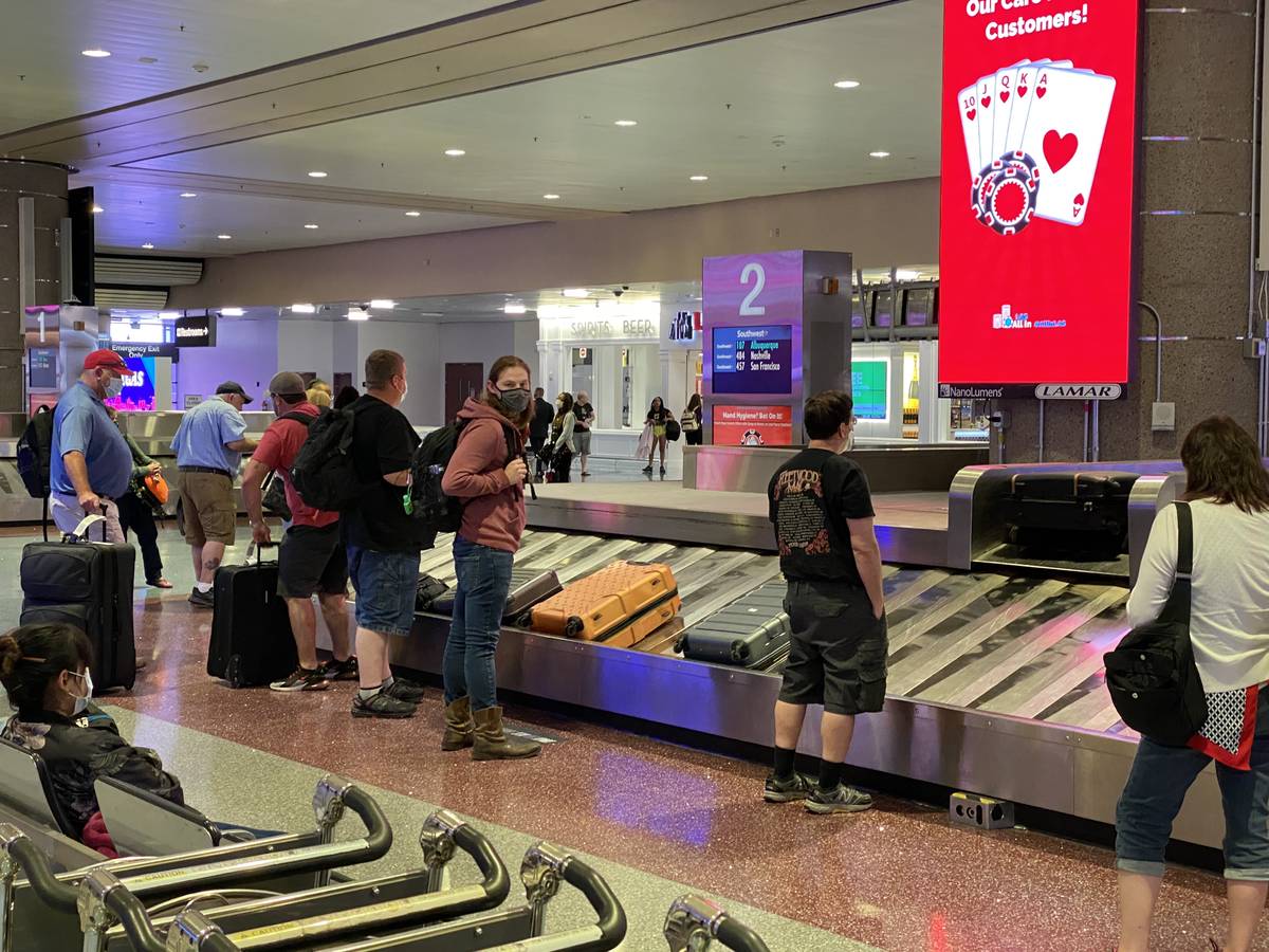 Travelers retrieve their luggage from carousel 2 in Terminal 1 at McCarran International Airpor ...