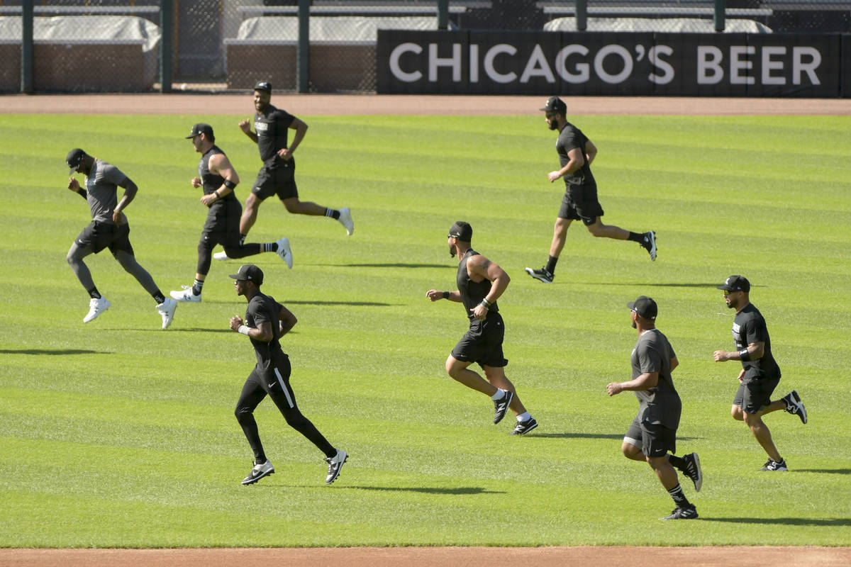 The Chicago White Sox warm up before practice at Guaranteed Rate Field, Sunday, July 5, 2020, i ...