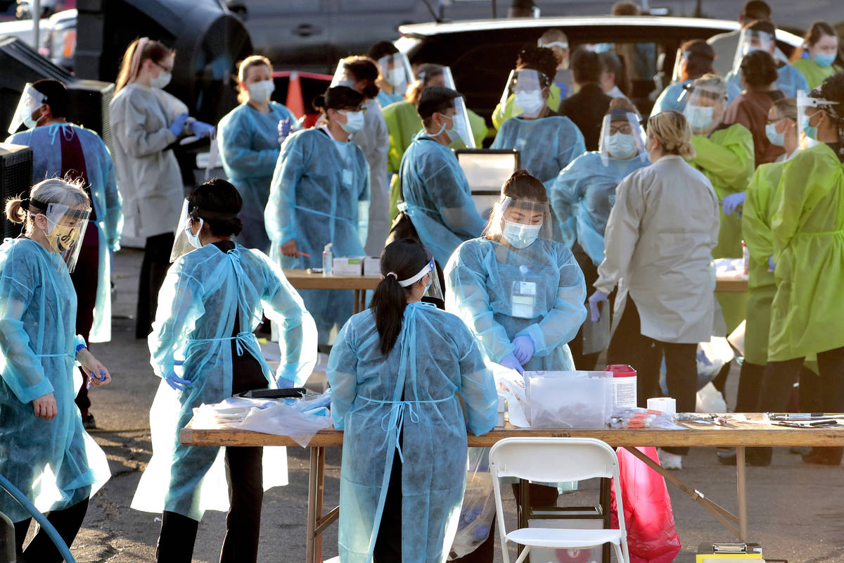 In a June 27, 2020, file photo, medical personnel prepare to test hundreds of people lined up i ...