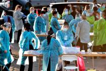 In a June 27, 2020, file photo, medical personnel prepare to test hundreds of people lined up i ...