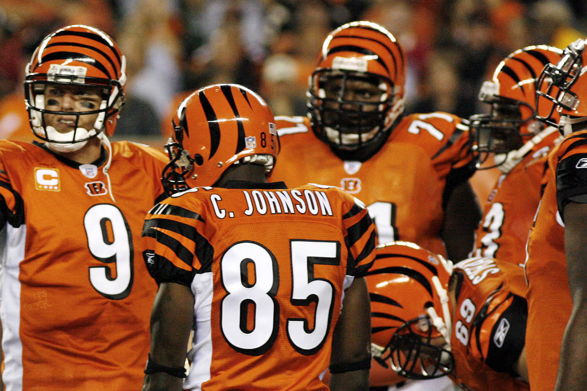 Cincinnati Bengals quarterback Carson Palmer, gesters as receiver Chad Johnson (81) looks on du ...