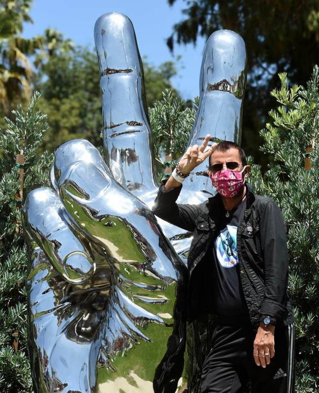 Musician Ringo Starr poses in front of his "Peace and Love" public sculpture on his 8 ...