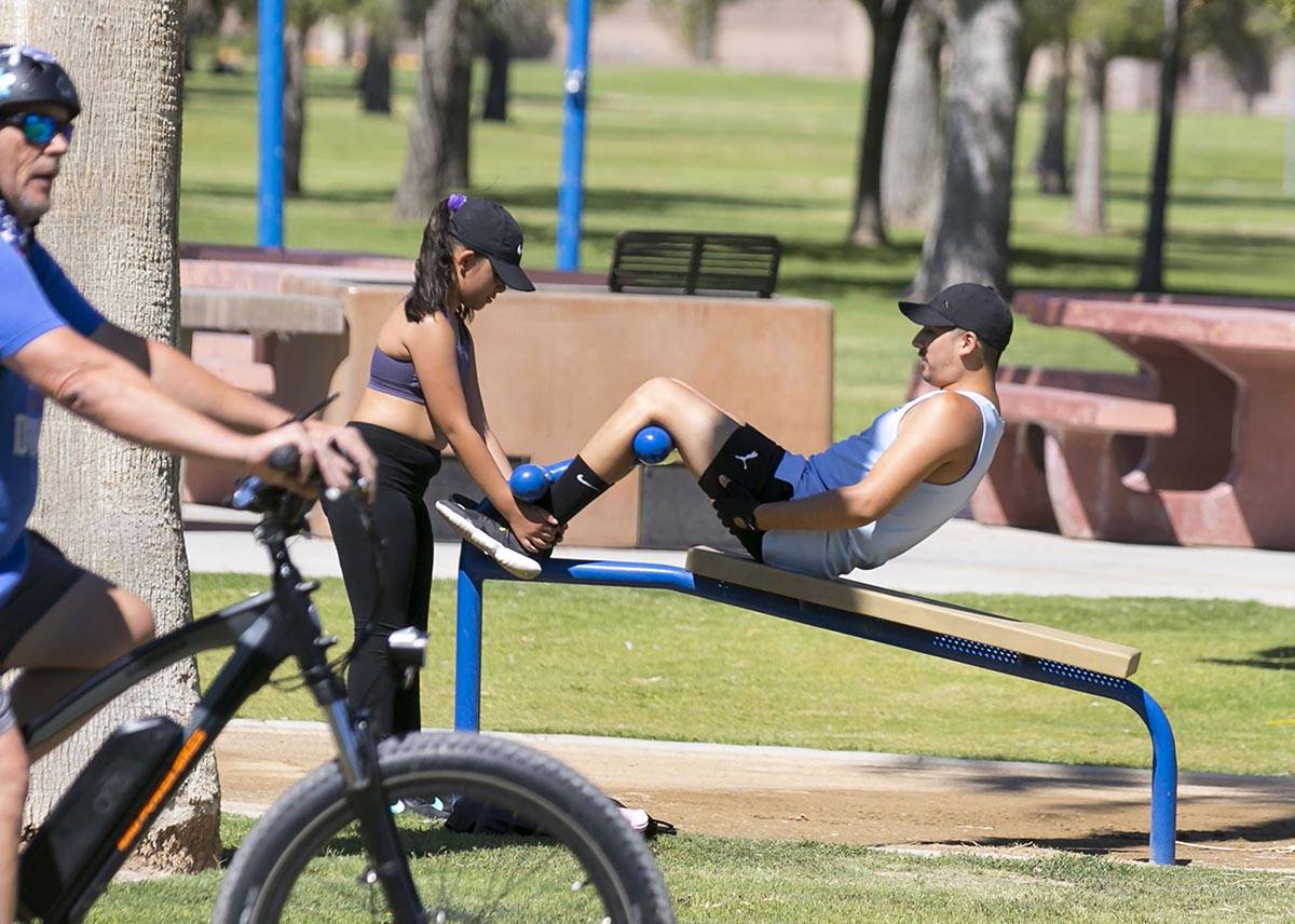 Cruz Lora, right, and his niece Bella exercise at Sunset Park on Wednesday, July 8, 2020, in La ...