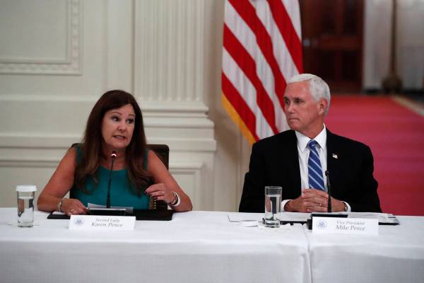 Vice President Mike Pence listens as second lady Karen Pence speaks during a "National Dia ...