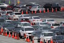 Lines of cars wait at a drive-through coronavirus testing site, Sunday, July 5, 2020, outside H ...