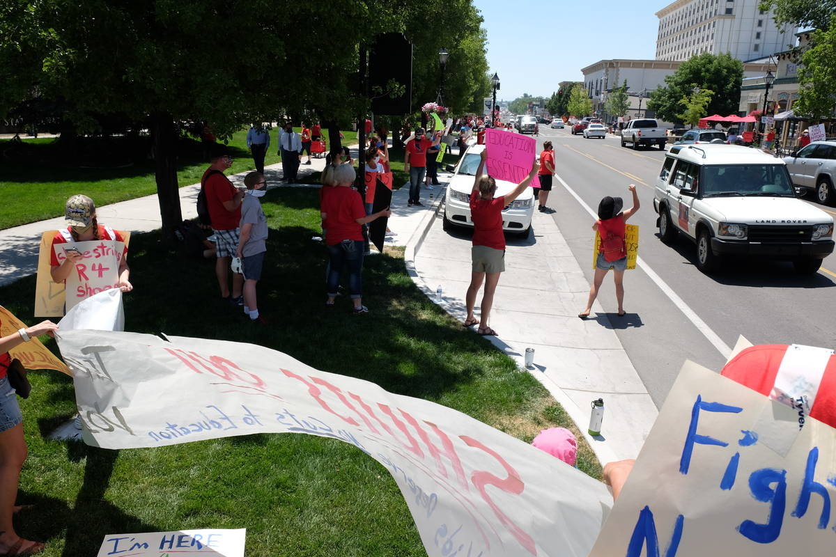 Education advocates protesting possible state budget cuts line Carson Street outside the Nevada ...