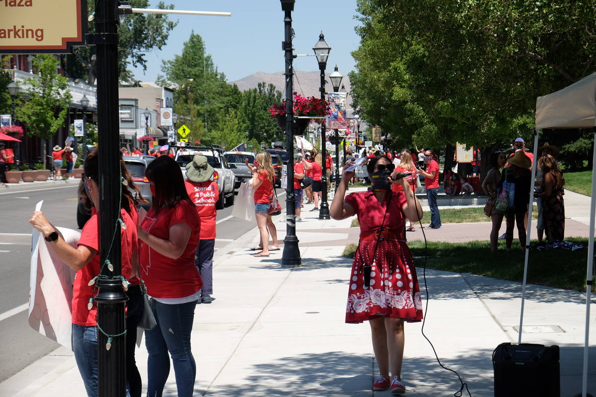 Education advocates protesting possible state budget cuts line Carson Street outside the Nevada ...