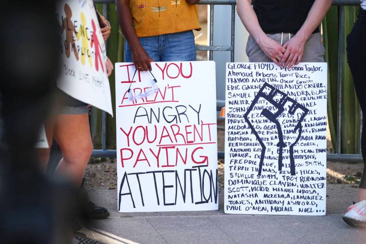 People participate in a Black Lives Matter protest outside of Las Vegas City Hall on Wednesday, ...