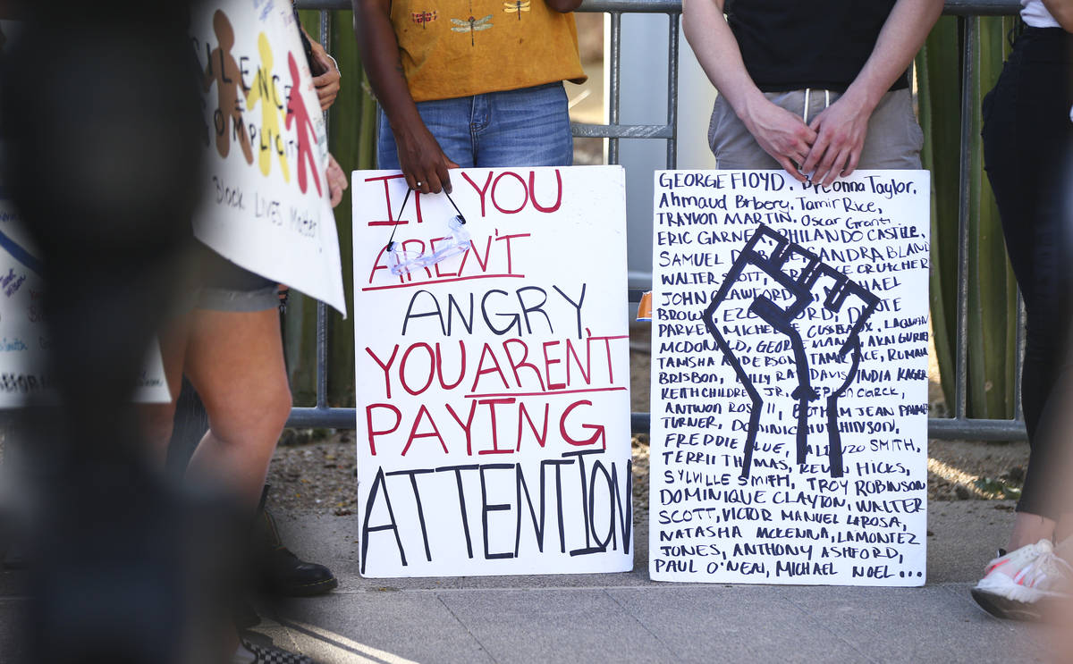 People participate in a Black Lives Matter protest outside of Las Vegas City Hall on Wednesday, ...