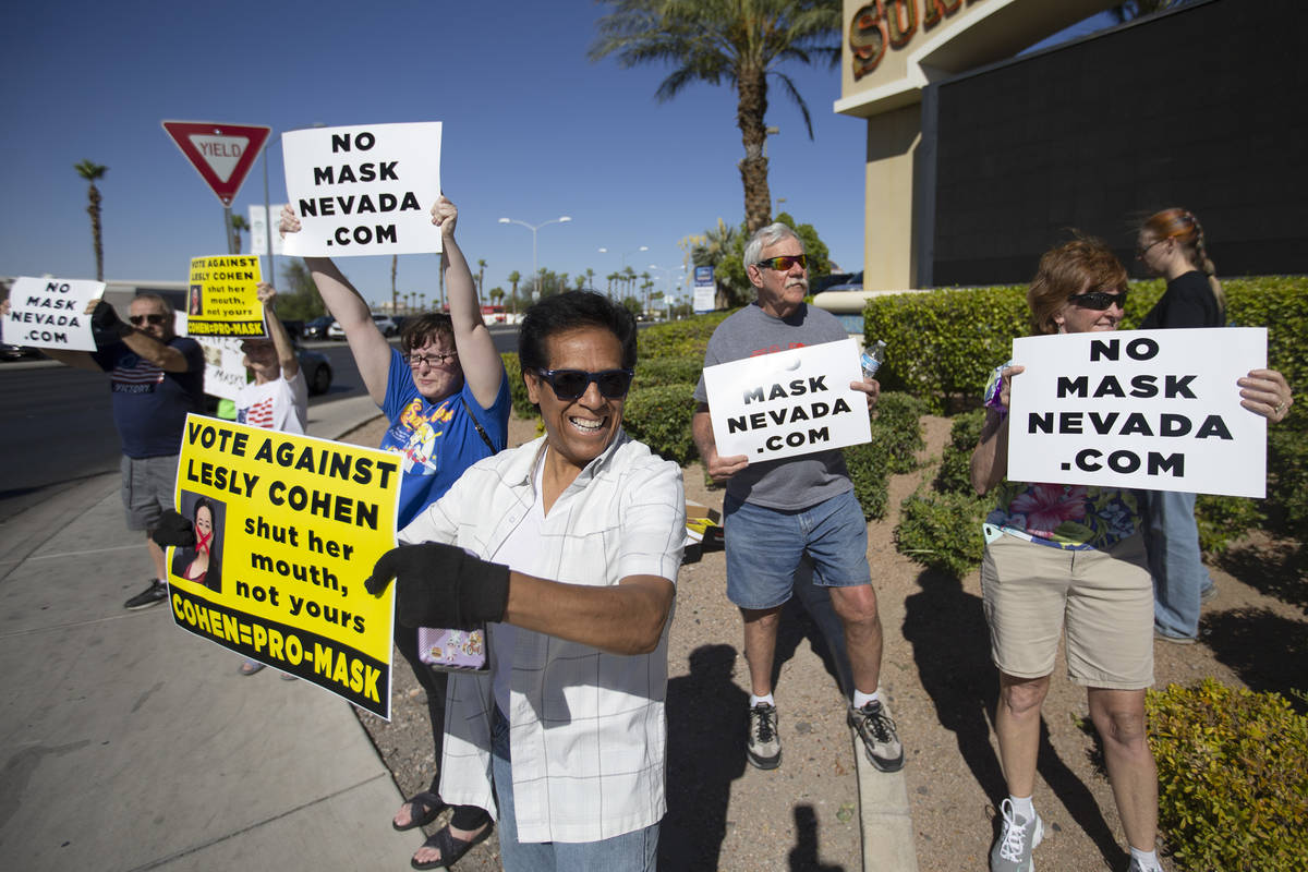 Jose Luis, of Las Vegas, participates in the "No Mask Protest" at the intersection of ...